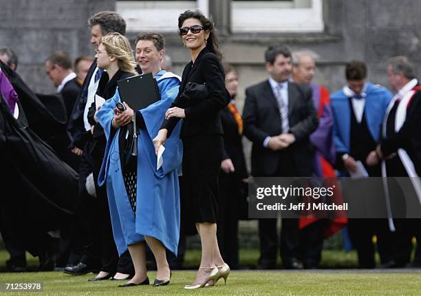 Catherine Zeta Jones watches her husband Michael Douglas getting photographed after receiving his honorary degree from St Andrews University on June...