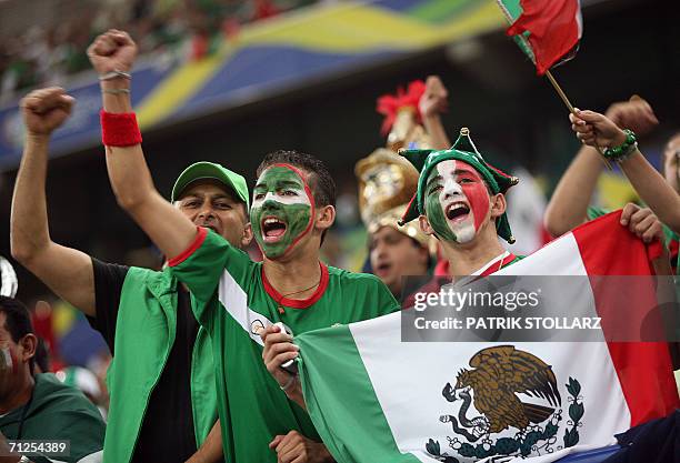 Gelsenkirchen, GERMANY: Mexican supporters wave national flag prior to the World Cup 2006 group D football game Portugal vs. Mexico, 21 June 2006 at...