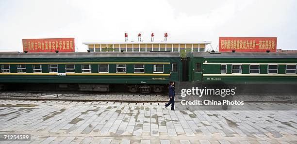 Work walks on the platform of Geermu Railway Station, part of Xining-Geermu section of the Qinghai-Tibet Railway on June 20, 2006 in Geermu City of...
