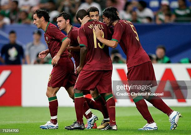 Sabrosa Simao of Portugal is congratulated by team mates after scoring the second goal of the game from the penalty spot during the FIFA World Cup...
