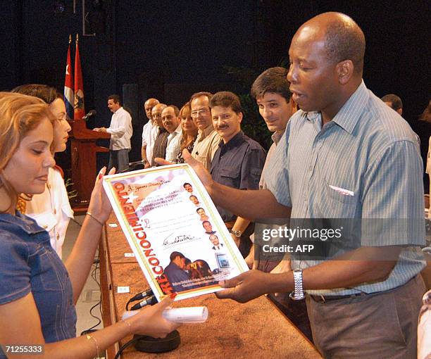 Fotografia tomada en el ano 2005, del integrante del Buro Politico del Partido Comunista de Cuba , Juan Carlos Robinson entregando diplomas a...