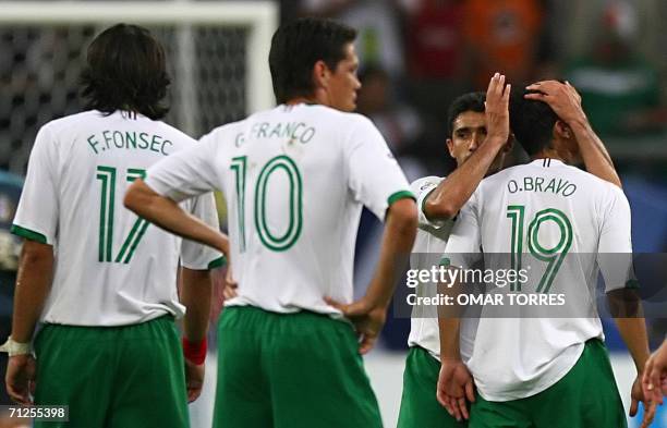 Gelsenkirchen, GERMANY: Mexican forward Omar Bravo, forward Guillermo Franco and forward Francisco Fonseca looks dejected at the endof the World Cup...