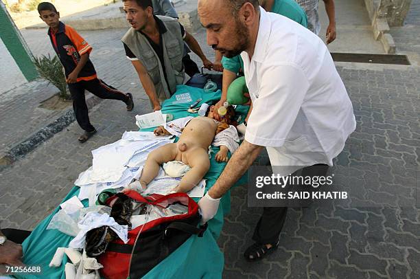 Palestinian medic rushes an injured baby into the Naser hospital in the southern Gaza Strip town of Khan Yunis 21 June 2006, following an Israeli air...