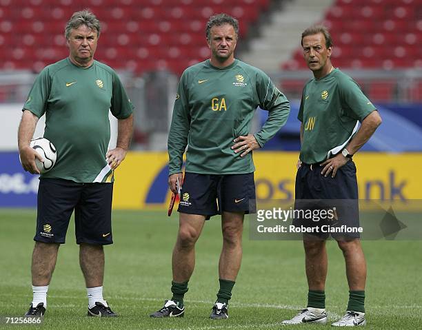 Australian coach Guus Hiddink and assistants Graham Arnold and Johan Neeskans look on during the Australian training Session at the Gottlieb-Daimler...