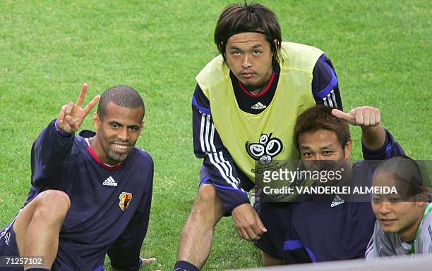 Japanese players Alessandro Santos , Yasuhito Endo and Yoichi Doi smile next to an unidentified assistant, during a training session, 21 June 2006,...