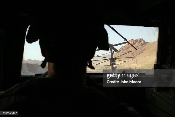 An American soldier drives through the rugged landscape June 21, 2006 west of Qalat, in the southern province of Zabul, Afghanistan. American,...