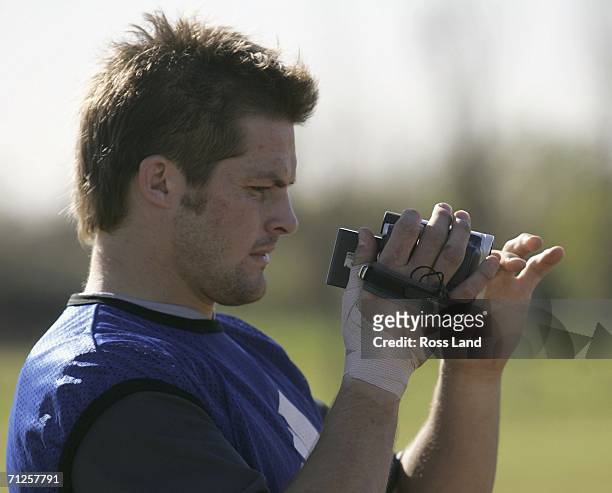 Richie McCaw mans the video camera during All Black training at the Centro Naval ground June 21, 2006 in Buenos Aires, Argentina. New Zealand play...