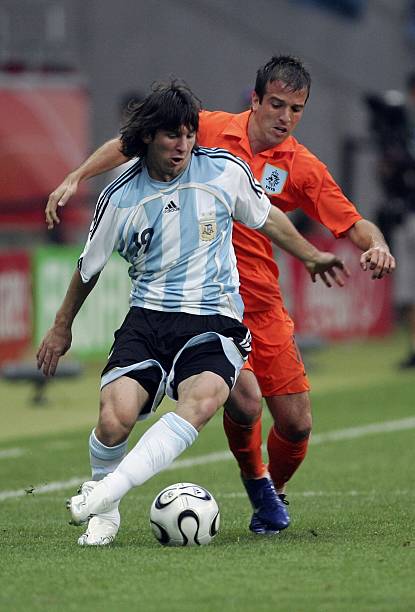 Lionel Messi of Argentina is challenged by Rafael Van Der Vaart of the Netherlands during the FIFA World Cup Germany 2006 Group C match between...