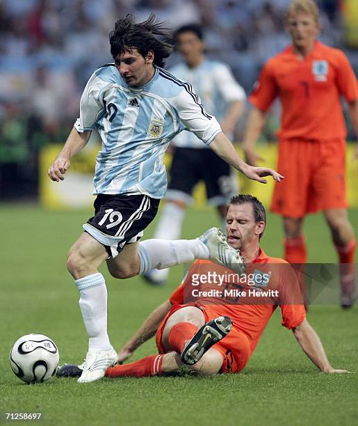 Lionel Messi of Argentina is challenged by Andre Ooijer of the Netherlands during the FIFA World Cup Germany 2006 Group C match between Netherlands...