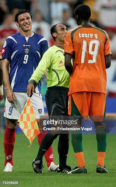 The assistant referee steps in between Savo Milosevic of Sebia & Montenegro and Yaya Toure of Ivory Coast during the FIFA World Cup Germany 2006...