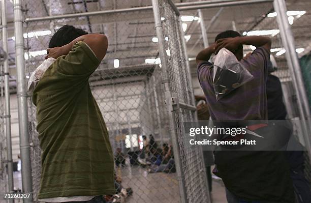 Men who were caught crossing the U.S. Border with Mexico illegally are processed in a holding cell June 21, 2006 at the U.S. Border Patrol processing...