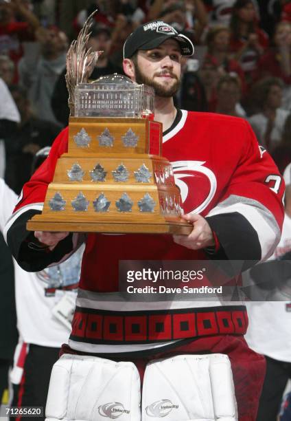 Goaltender Cam Ward of the Carolina Hurricanes poses with the Conn Smythe trophy after defeating the Edmonton Oilers in game seven of the 2006 NHL...