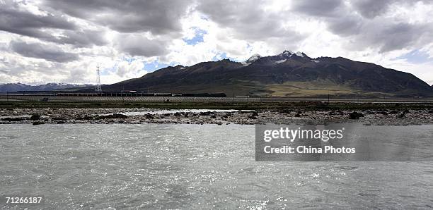 Train passes along a rail bridge which is part of the Qinghai-Tibet Railway, on June 21, 2006 in Tibetan Autonomous Region, China. The Qinghai-Tibet...