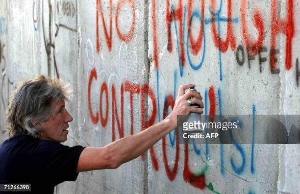 Roger Waters, British rock legend and co founder of the group Pink Floyd, paints a graffiti at Israel?s separation barrier surrounding the West Bank...