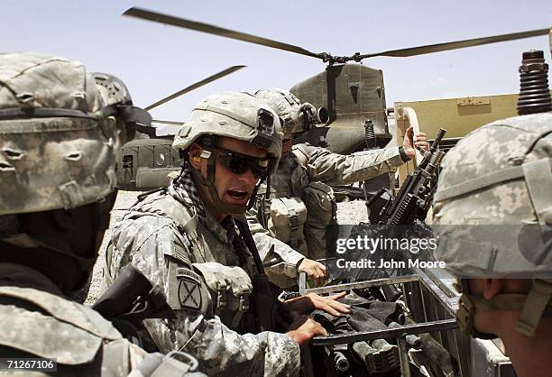 American soldiers from the 10th Mountain Division arrive as part of Operation Mountain Thrust to a U.S. Base near the village of Deh Afghan on June...