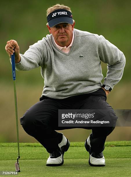 Colin Montgomerie of Scotland lines up a putt on the first hole during the first round of The Johnnie Walker Championship on The PGA Centenary Course...