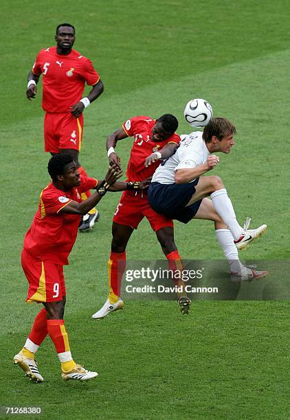 Derek Boateng and John Pantsil are beaten to the ball by Brian McBride of USA during the FIFA World Cup Germany 2006 match between Ghana and USA...