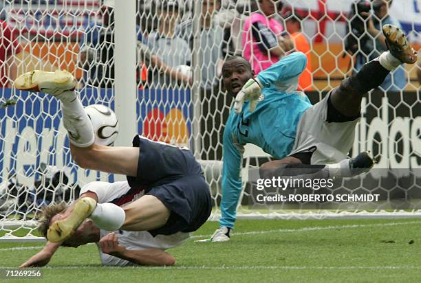 Forward Brian McBride clashes with Ghanaian goalkeeper Richard Kingston in front of the goal during the opening round Group E World Cup football...