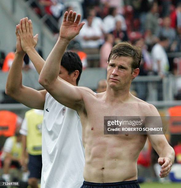 Forward Brian McBride waves to supporters following his team's loss in the opening round Group E World Cup football match between Ghana and the...