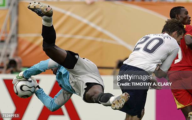 Ghanaian goalkeeper Richard Kingston makes a save as US forward Brian McBride clashes with Ghanaian defender John Pantsil during the opening round...