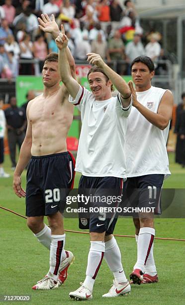 Forward Brian McBride , US midfielder John O'Brien and US forward Brian Ching dejectedly wave to supporters following the opening round Group E World...