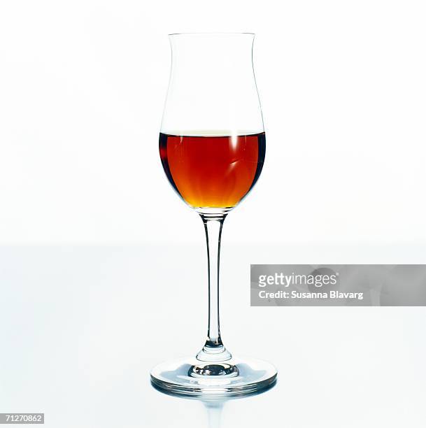 a glass of sherry on a white background, close-up. - sherry stock pictures, royalty-free photos & images