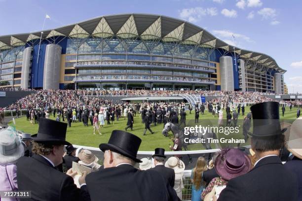 Racegoers watch jockeys and their horses preparing in the parade ring infront of the newly refurbished grandstand on ladies day at Royal Ascot Races...