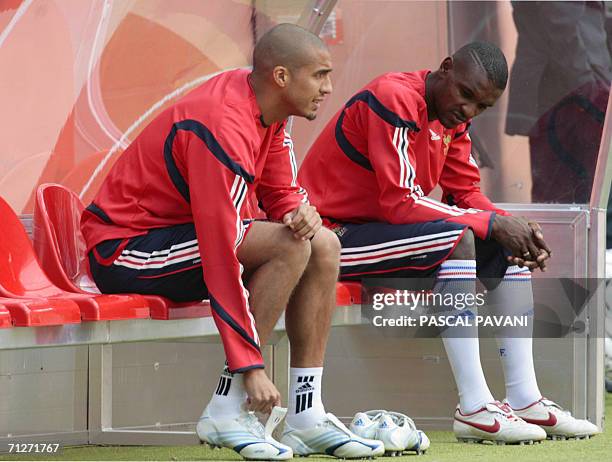 French David Trezeguet and defender Eric Abidal sit on a bench during a training session fat the Cologne stadium 22 June 2006, on the eve of their...