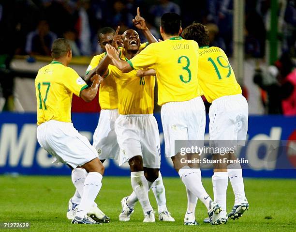 Gilberto of Brazil is congratulated by his team mates after scoring during the FIFA World Cup Germany 2006 Group F match between Japan and Brazil at...