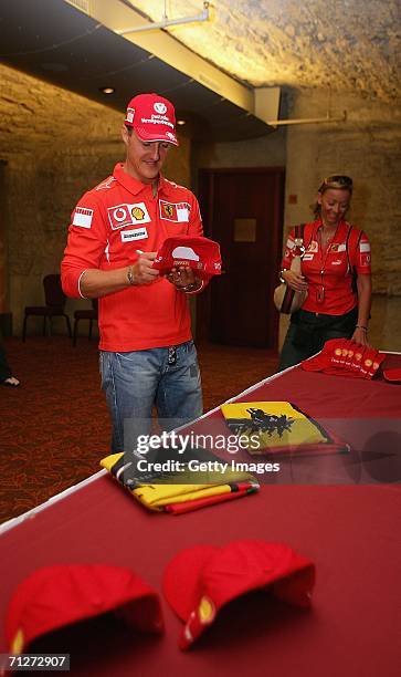 Michael Schumacher of Germany and Ferrari autographs mercahndise at a press conference ahead of the Grand Prix of Canada, June 22 in Montreal, Canada.