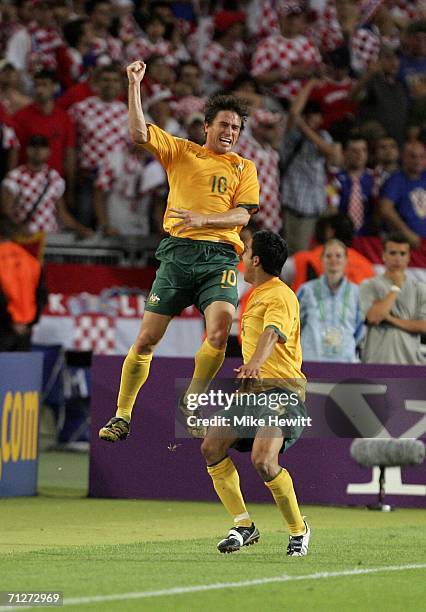 Harry Kewell of Australia celebrates with teammate Tim Cahill, after scoring his team's second goal to level the scores at 2-2 during the FIFA World...