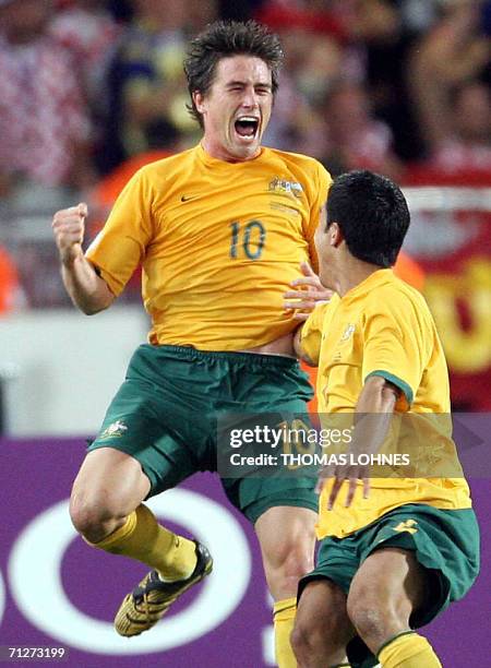 Australian forward Harry Kewell celebrates his 2-2 goal with teammate Australian midfielder Tim Cahill during the World Cup 2006 group F football...