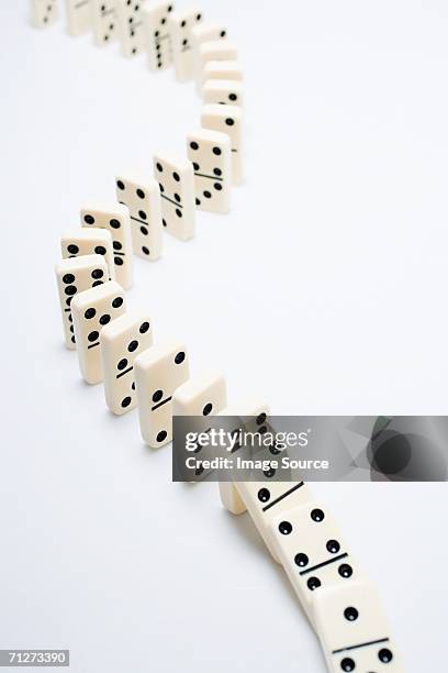 the domino effect - dominoes stock pictures, royalty-free photos & images