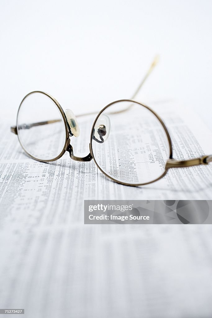 Glasses on financial pages