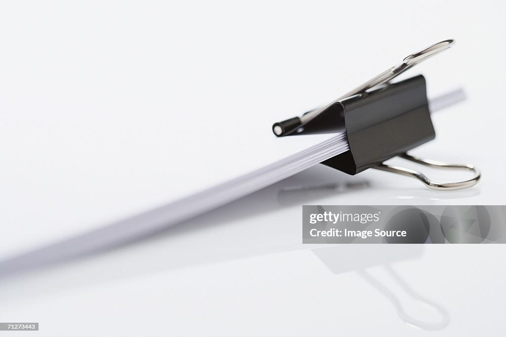 Binder clip holding paper
