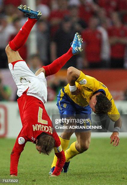 English midfielder David Beckham falls down during the opening round Group B World Cup football match Sweden vs. England, 20 June 2006 in Cologne,...
