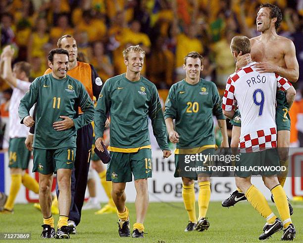 Australian defender Craig Moore wearing a Croatian jersey jubilates with defender Lucas Neill at the end of the World Cup 2006 group F football match...