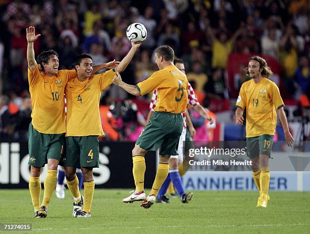 Teammates Harry Kewell , Tim Cahill and Jason Culina of Australia celebrate, following their team's 2-2 draw during the FIFA World Cup Germany 2006...