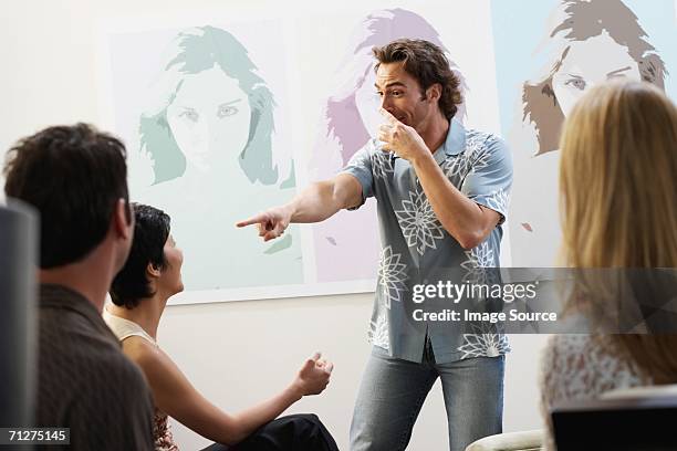 friends playing charades - mime stockfoto's en -beelden