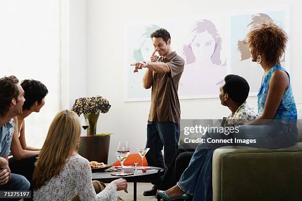 friends playing charades - mime stockfoto's en -beelden