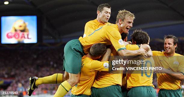 Australian midfielder Vince Grella , forward Harry Kewell jubilate after Australian defender Craig Moore scored a penalty during the World Cup 2006...