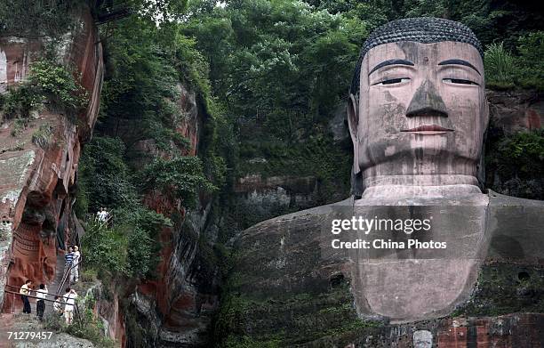 Tourists visit the Leshan Giant Buddha on June 22, 2006 in Leshan of Sichuan Province, China. The statue, built in 713 during the Tang Dynasty, is 71...