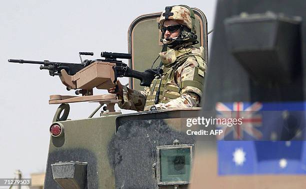 An Australian soldier guards the area during a joint street patrol with Iraqi security forces in the Iraqi southern city of Samawa 22 June 2006....