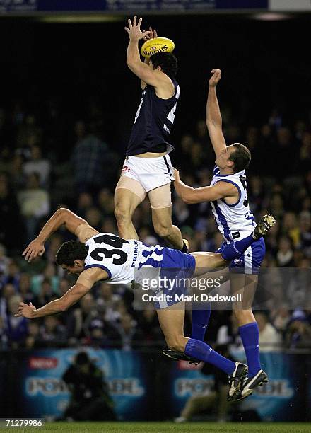 Brendan Fevola of the Blues flies for a mark over Ben Schwarze of the Kangaroos during the round 12 AFL match between the Kangaroos and Carlton at...
