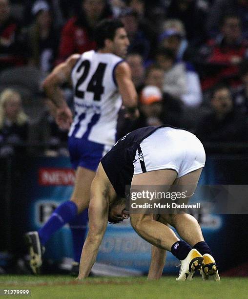 Brendan Fevola of the Blues attempts to stand up after injuring himself during the round 12 AFL match between the Kangaroos and Carlton at the...