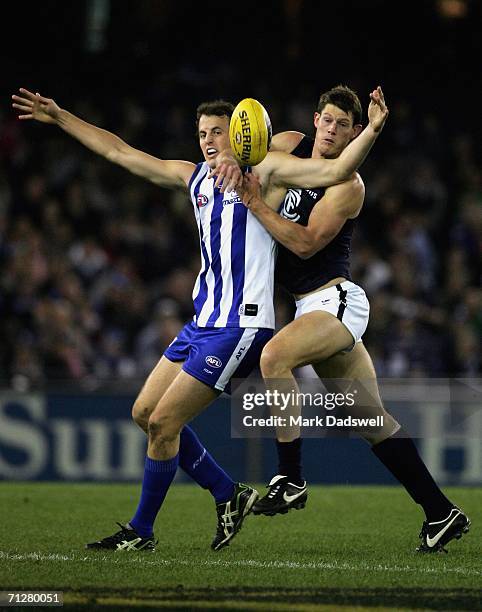 David Hale of the Kangaroos appeals for a free kick from Barnaby French of the Blues during the round 12 AFL match between the Kangaroos and Carlton...