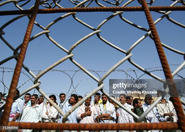 Iraqi prisoners wait to be released on June 23, 2006 at Abu Ghraib prison west of Baghdad, Iraq. More than 500 Iraqi detainees were released from Abu...