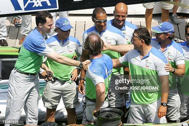 Spain's Prince Felipe shakes hands with members of the Desafio Espanol team, the Spanish America's Cup challenge at the docks in Valencia, 23 June...