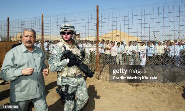 Iraqi former Deputy Prime Minister Abd Mutlaqi al-Jabouri was with a U.S soldier as he attends the release of more than 500 Iraqi prisoners on June...