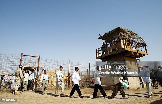 Iraqi freed prisoners walk out of Abu Ghraib prison on June 23, 2006 west of Baghdad, Iraq. More than 500 Iraqi detainees were released from Abu...